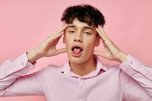 portrait of a young man posing fashion pink shirt modern style isolated background unaltered photo