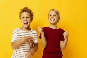 two joyful children standing side by side posing childhood emotions isolated background photo