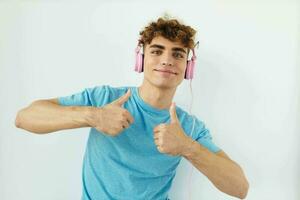 Attractive man in pink headphones music emotions isolated background photo