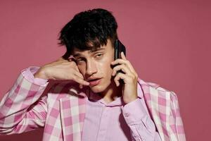 handsome guy fashionable talking on the phone pink blazer posing studio Lifestyle unaltered photo