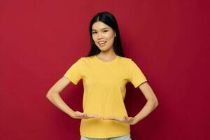 pretty brunette in a yellow t-shirt gesturing with his hands fun isolated background unaltered photo