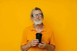 old man in a yellow T-shirt a glass with a drink monochrome shot photo