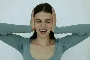 cheerful brunette gesturing with her hands close-up light background photo