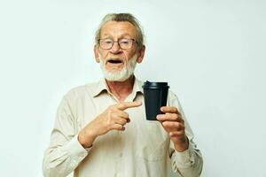 Portrait of happy senior man in a shirt and glasses a black glass cropped view photo