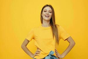 cute red-haired girl in a yellow t-shirt yellow background photo