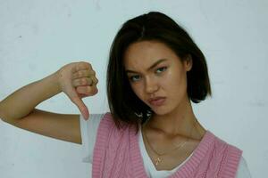 pretty brunette in pink vest posing hand gesture photo