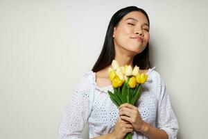 woman romance bouquet of flowers near the face studio model unaltered photo