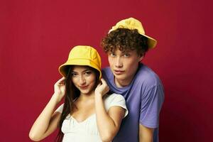 Man and woman in colorful t-shirts stylish clothes hats isolated background photo