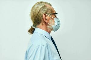 Portrait elderly man in shirt with tie medical mask safety light background photo