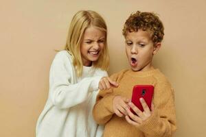 Portrait of cute children hug entertainment selfie posing friendship beige background photo