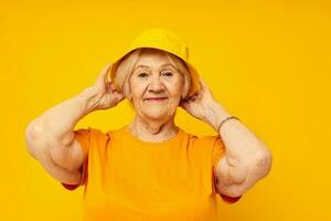 Photo of retired old lady in casual t-shirt yellow panama close-up emotions