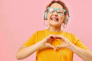 funny girl wearing blue glasses listening to music on headphones cropped view unaltered photo