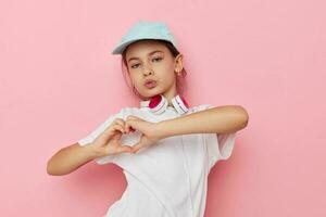 Portrait of happy smiling child girl wearing headphones posing emotions isolated background photo