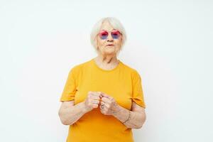 Photo of retired old lady in fashionable glasses hand gestures isolated background