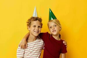 Boy and girl smiling and posing in casual clothes against on colored background photo