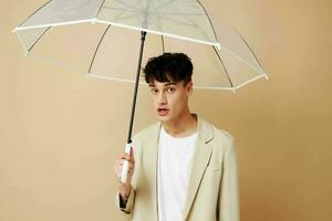 nice guy in a jacket with an open umbrella protection from the rain photo