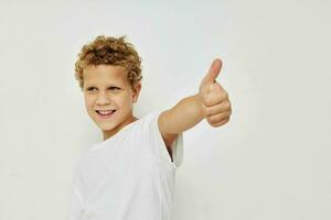 Photo of young boy children's style fashion emotions beige background