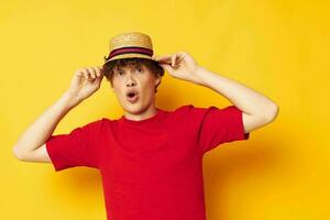 guy with red curly hair in a red t-shirt with a fashion hat yellow background unaltered photo