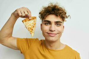 Attractive man eating pizza posing close-up isolated background photo