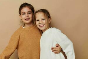 two funny little girls in sweaters posing childhood photo