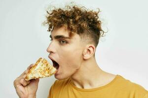 Attractive man eating pizza posing close-up Lifestyle unaltered photo