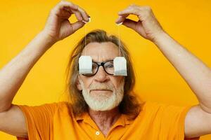 elderly man disposable tea bags near face yellow background photo