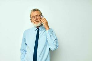 Photo of retired old man talking on the phone business work isolated background