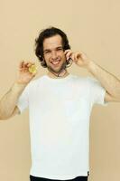 Cheerful man in a white T-shirt with Bitcoin cryptocurrency isolated background photo