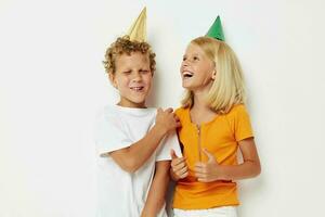 picture of positive boy and girl with caps on his head holiday entertainment light background photo