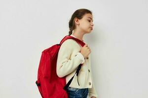 cute schoolgirl with red backpack posing Lifestyle unaltered photo