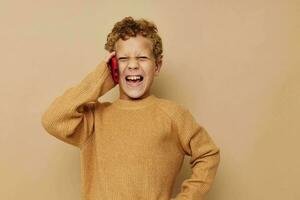 smiling boy in a sweater with a phone in his hands communication photo