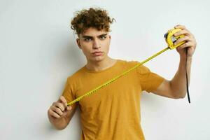 Attractive man grimace measuring tape posing isolated background photo
