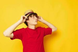 cute red-haired guy in a red t-shirt with a fashion hat isolated background unaltered photo