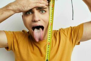 kinky guy grimace measuring tape posing isolated background photo