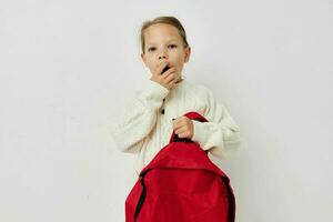 little girl red backpack stylish clothes isolated background photo