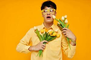 Photo of romantic young boyfriend give flowers wear spectacles yellow shirt Lifestyle unaltered