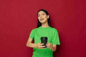 pretty brunette smile green t-shirt black disposable cups fashion studio model unaltered photo