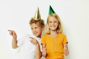 Boy and girl posing emotions holiday colorful caps isolated background unaltered photo