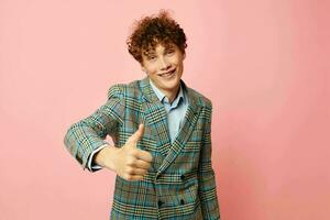 portrait of a young curly man gesturing with his hands emotions checkered jacket Lifestyle unaltered photo