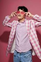 portrait of a young man self confidence pink plaid blazer fashion posing pink background unaltered photo