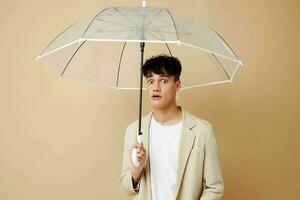 nice guy in a jacket with an open umbrella protection from the rain photo