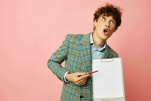 portrait of a young curly man in a plaid jacket copy-space folder isolated background unaltered photo