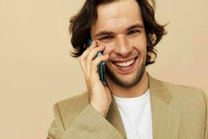 handsome man communication by phone beige suit elegant style isolated background photo