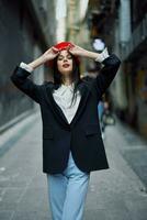 Fashion woman portrait walking tourist in stylish clothes with red lips walking down narrow city street, travel, cinematic color, retro vintage style, dramatic look without smile sadness. photo