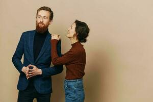 Man and woman couple in a relationship smile and interaction on a beige background in a real relationship between people photo