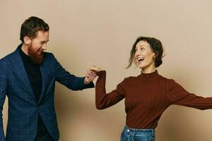 Man and woman couple in a relationship smile and interaction on a beige background in a real relationship between people photo