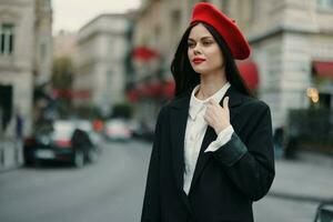 Fashion woman portrait standing on the street in front of the city in stylish clothes with red lips and red beret, travel, cinematic color, retro vintage style, urban fashion lifestyle. photo