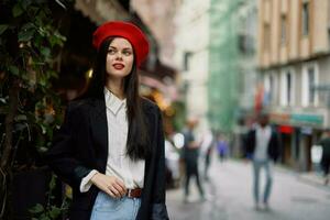 Woman smile fashion model walks on the street in the city center among the crowd in a jacket and red beret and jeans, cinematic french fashion style clothing, travel to istanbul photo