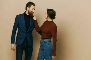 Man and woman couple in a relationship smile and interaction on a beige background in a real relationship between people photo