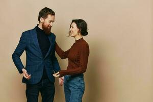 Man and woman couple in a relationship smile and interaction on a beige background in a real relationship between people photo